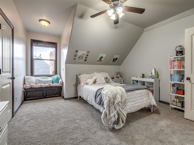 carpeted bedroom with ceiling fan and vaulted ceiling