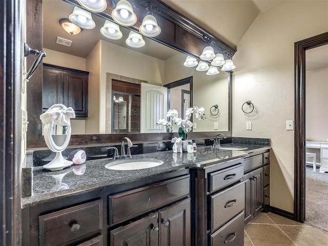 bathroom featuring tile patterned flooring, vanity, vaulted ceiling, and an enclosed shower