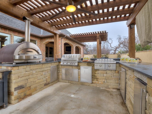 view of patio with exterior kitchen, a grill, ceiling fan, and a pergola