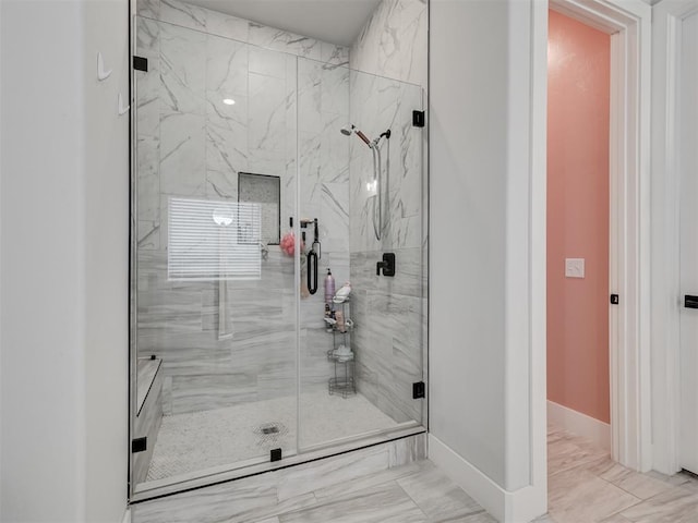 bathroom with a shower with door