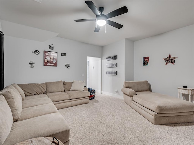 living room with ceiling fan and carpet