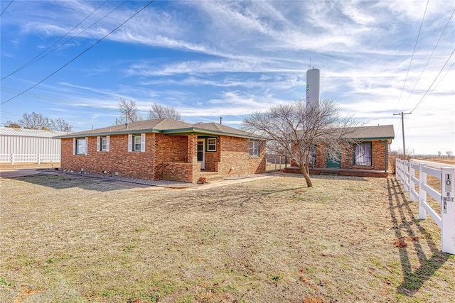 back of property featuring a lawn