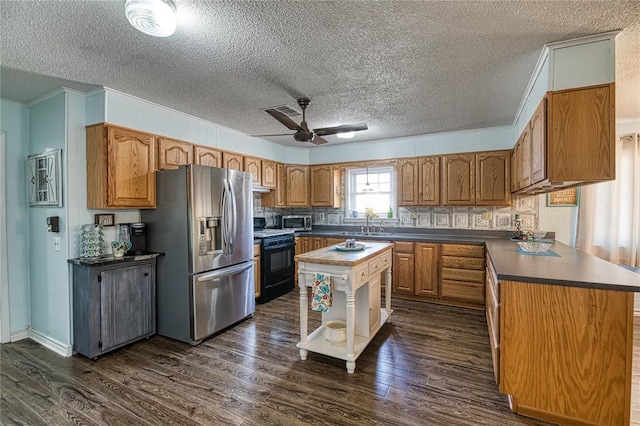 kitchen featuring dark hardwood / wood-style floors, black range, a center island, and stainless steel fridge with ice dispenser