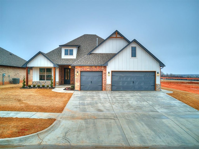 view of front of home featuring a garage and central AC