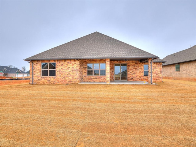 back of property featuring a yard and a patio area