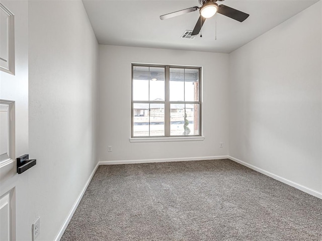 carpeted spare room featuring ceiling fan