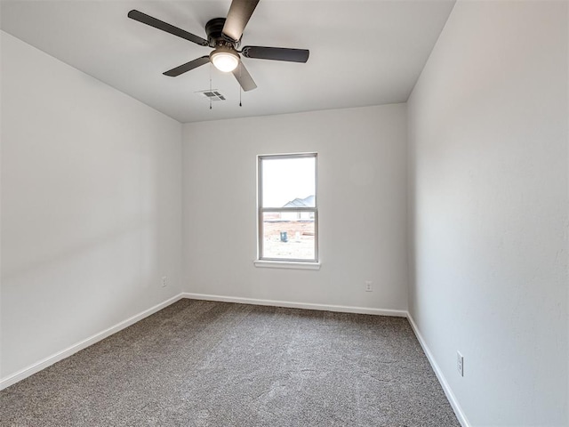 carpeted spare room with ceiling fan