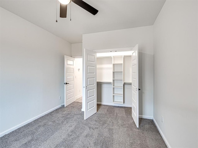 unfurnished bedroom with ceiling fan, carpet flooring, and a closet