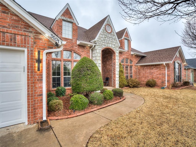 view of front of house with a garage and a front yard