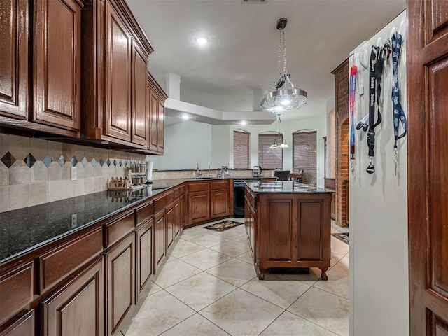 kitchen featuring dishwasher, light tile patterned floors, decorative backsplash, and decorative light fixtures