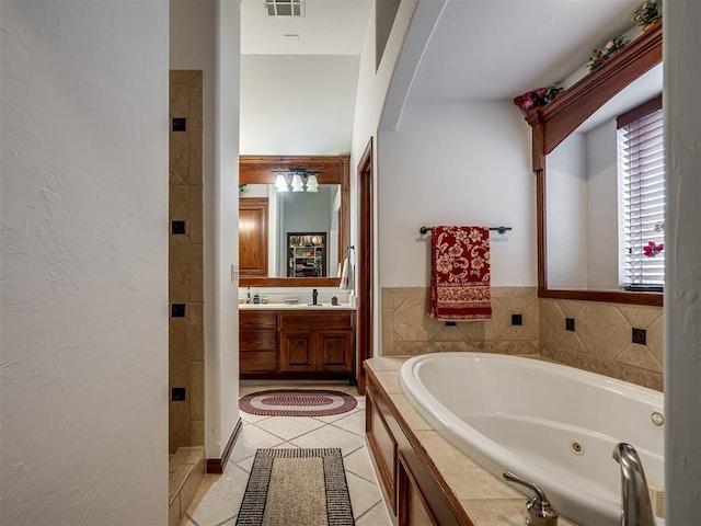 bathroom featuring tile patterned floors, independent shower and bath, and vanity