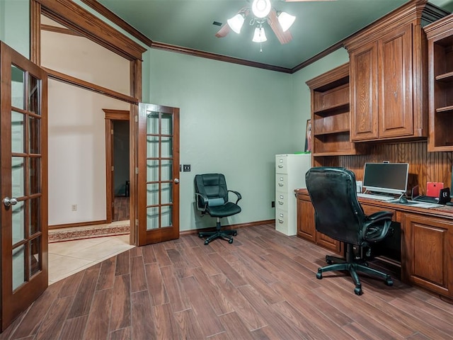 home office with crown molding, wood-type flooring, and french doors