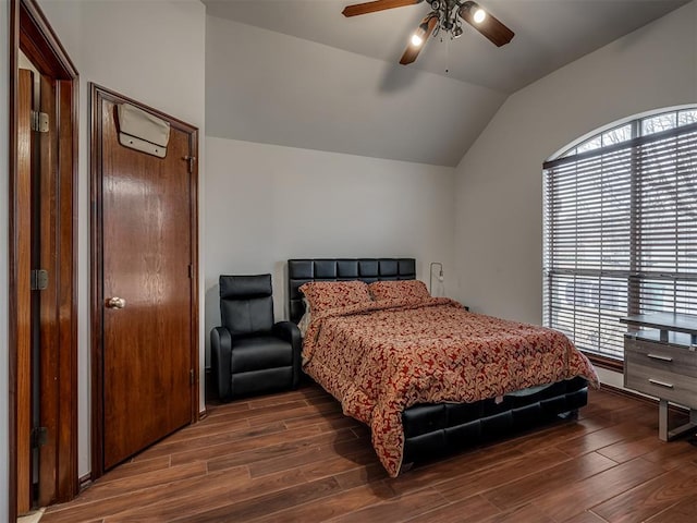 bedroom with multiple windows, ceiling fan, lofted ceiling, and dark hardwood / wood-style flooring