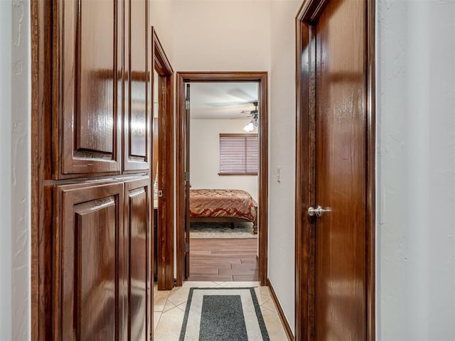 hall featuring light tile patterned floors