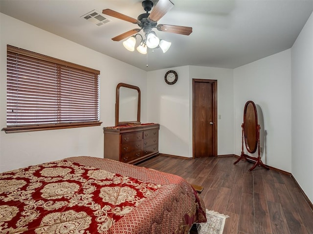 bedroom with ceiling fan and dark hardwood / wood-style floors