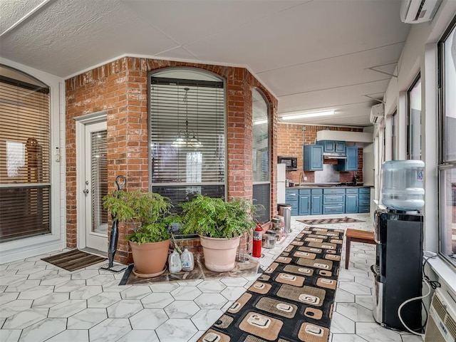 view of patio featuring sink and a wall unit AC