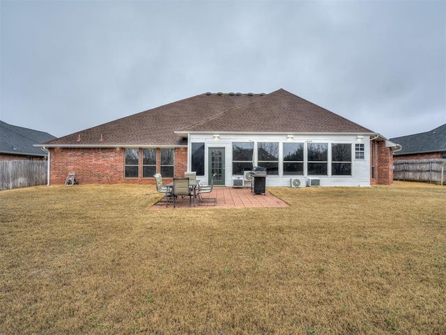 back of house with a yard and a patio