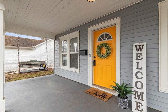 view of exterior entry with covered porch