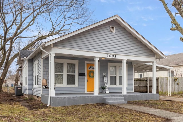 bungalow featuring covered porch and central air condition unit