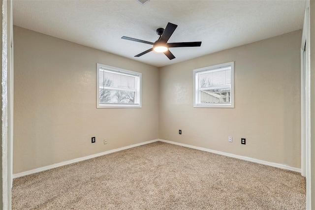 unfurnished room with ceiling fan and carpet flooring