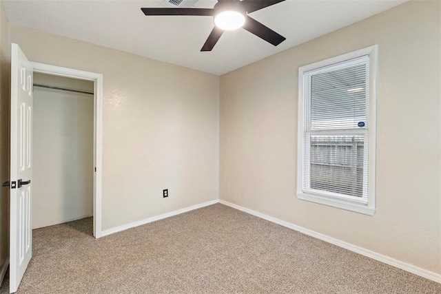 unfurnished bedroom featuring ceiling fan and light carpet