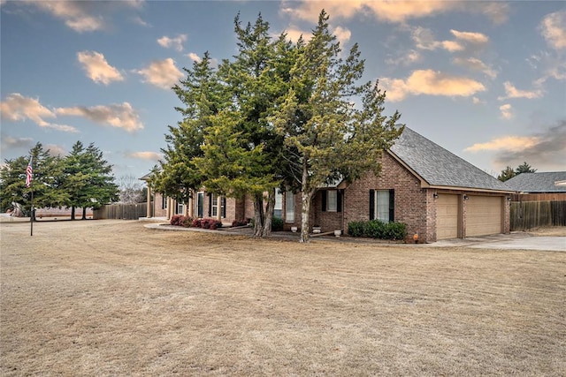 view of property hidden behind natural elements with a garage