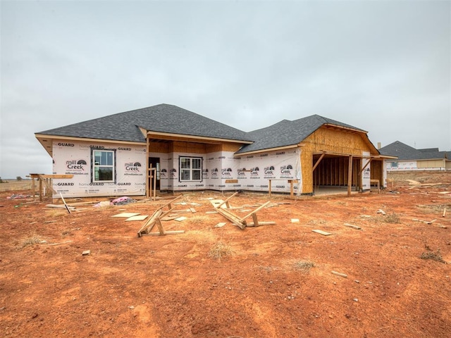 property under construction with roof with shingles