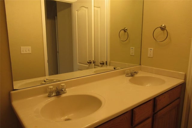 full bathroom featuring double vanity and a sink