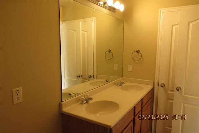 full bath with double vanity and a sink