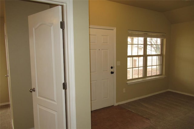 interior space with tile patterned flooring, baseboards, carpet, and lofted ceiling