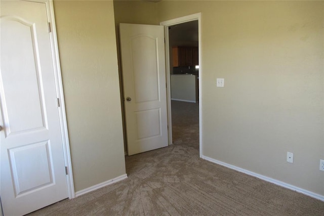 unfurnished bedroom featuring baseboards and carpet floors