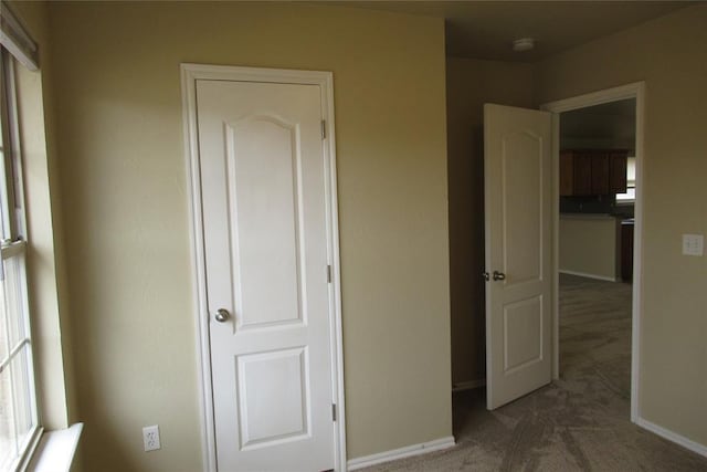 unfurnished bedroom featuring baseboards and carpet floors