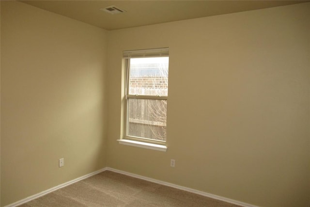 unfurnished room featuring visible vents, baseboards, and carpet flooring