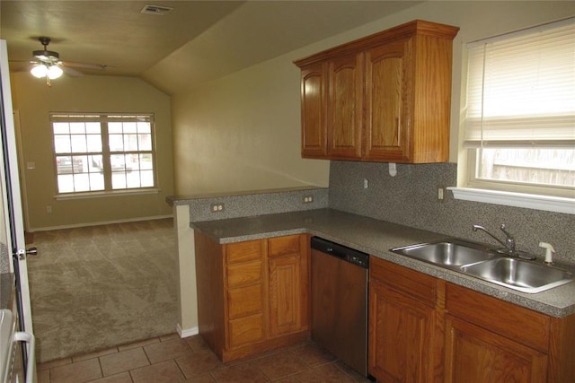 kitchen with dishwashing machine, carpet, visible vents, lofted ceiling, and a sink