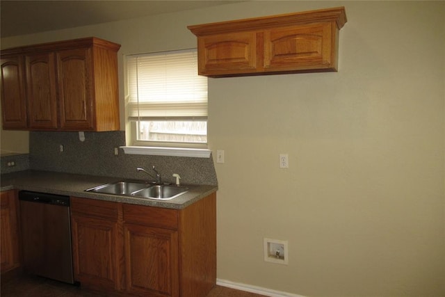 kitchen with tasteful backsplash, dishwasher, brown cabinetry, and a sink