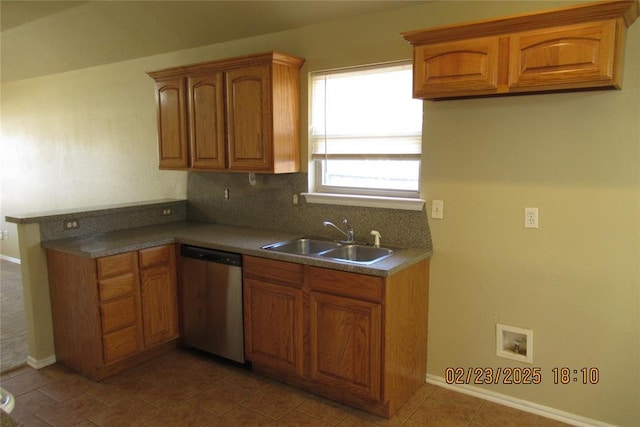 kitchen featuring brown cabinetry, a sink, and stainless steel dishwasher