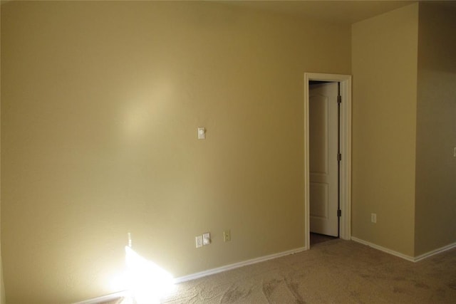 unfurnished room featuring carpet flooring and baseboards