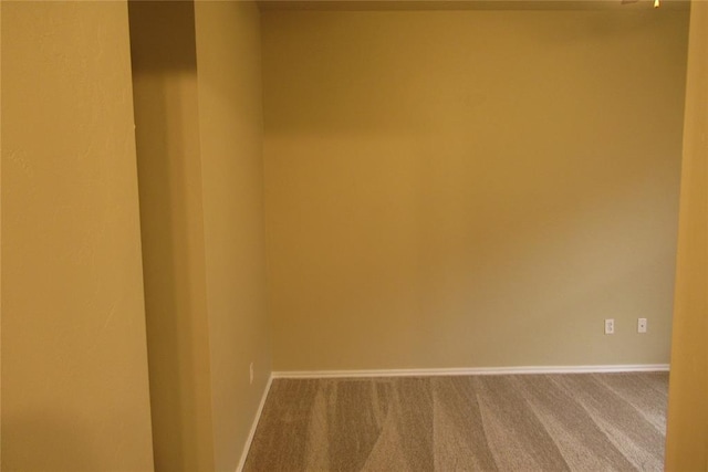 carpeted empty room with baseboards