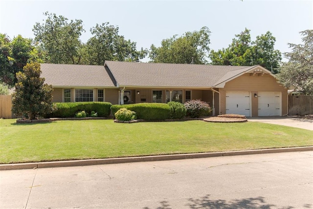 ranch-style home with a garage and a front yard