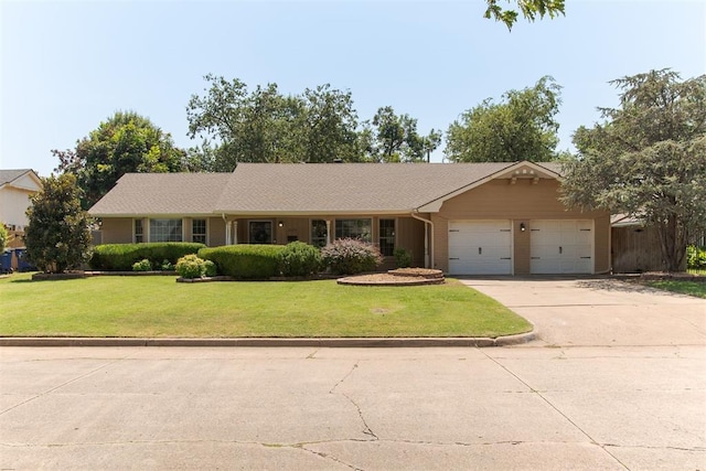 single story home featuring a garage and a front lawn