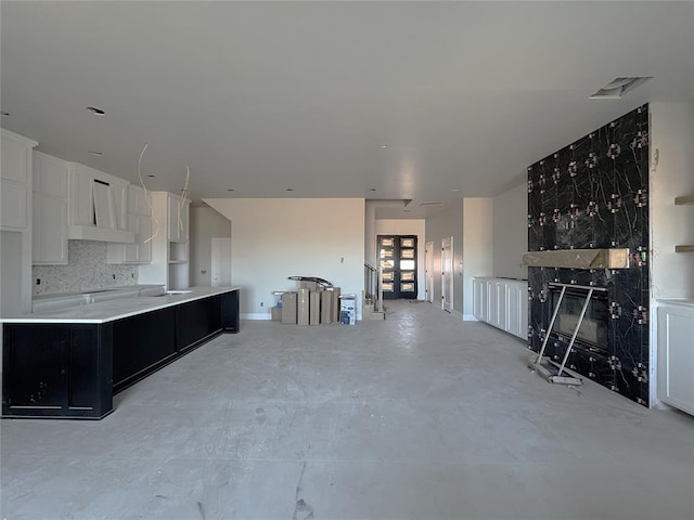 kitchen with white cabinetry and backsplash