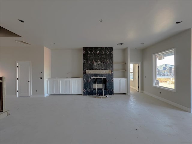 unfurnished living room with a premium fireplace