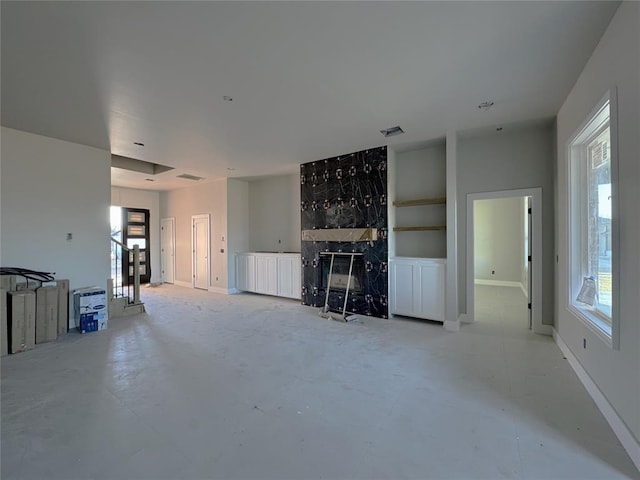 unfurnished living room with plenty of natural light