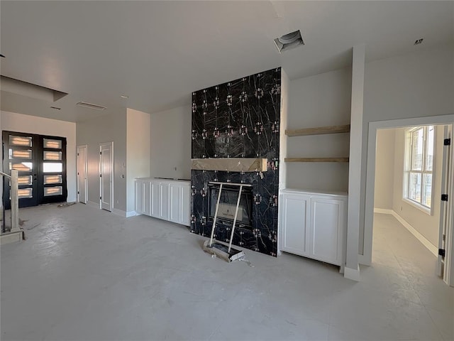 unfurnished living room featuring plenty of natural light