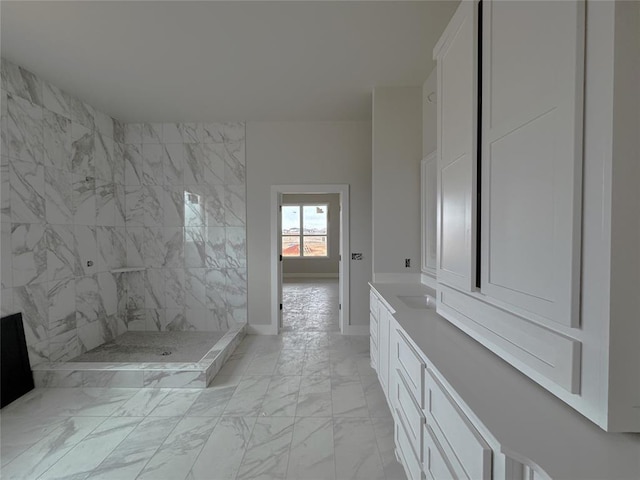 bathroom featuring vanity and tiled shower