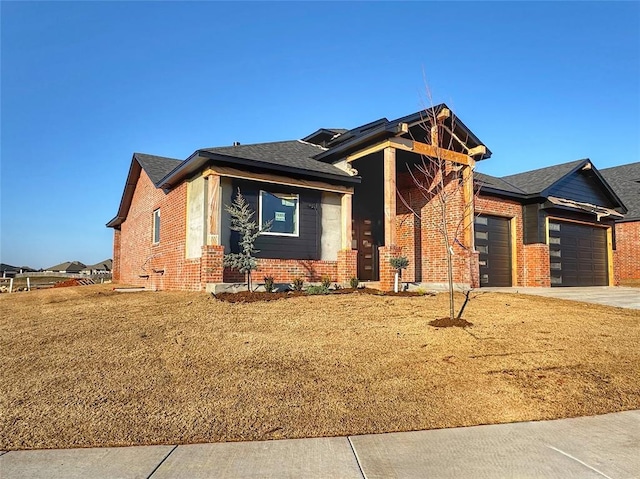 view of front of home featuring a garage and a front lawn