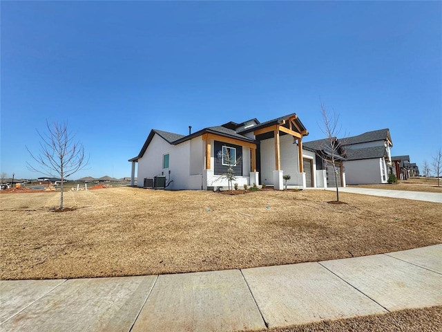 7225 NW 154th St, Edmond, OK 73013 - view of front of property featuring stucco siding, concrete driveway, central air condition unit, and a garage