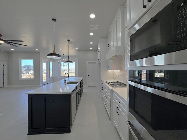 7225 NW 154th St, Edmond, OK 73013 - kitchen with light countertops, stainless steel appliances, visible vents, and a sink