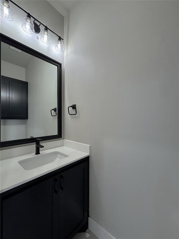 7225 NW 154th St, Edmond, OK 73013 - bathroom featuring baseboards and vanity