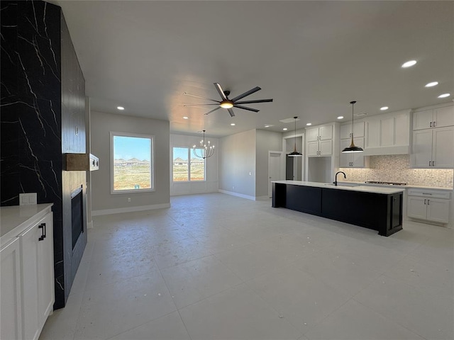 7225 NW 154th St, Edmond, OK 73013 - kitchen featuring tasteful backsplash, baseboards, recessed lighting, ceiling fan with notable chandelier, and a large fireplace